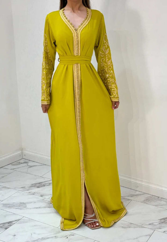 A yellow kaftan with long sleeves and decorative detailing, featuring a loose fit and maxi length.