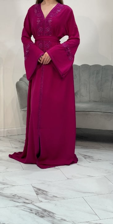 Purple dress with intricate designs on a neutral background